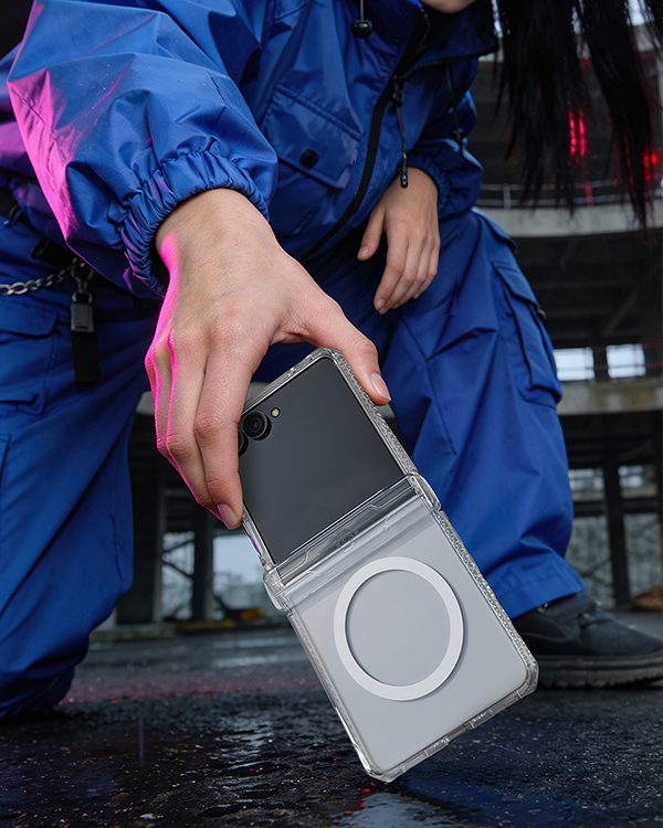 A person in a blue outfit holding Galaxy Z Flip8 in clear case.
